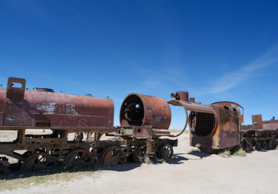 On the outskirts of the desert town of Uyuni, high on the Andean plain, steel giants have been destroyed by salt winds. 